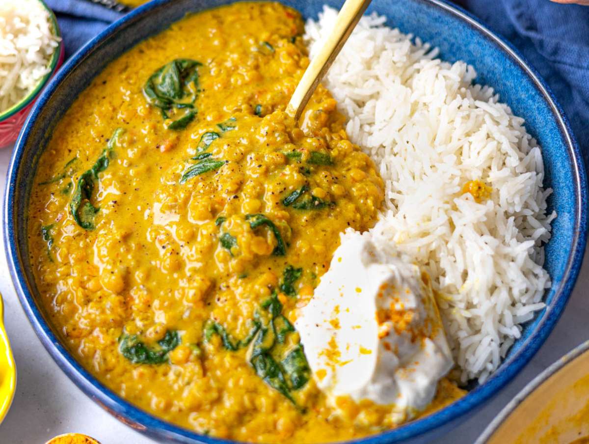 Step 6 Red lentil dal served in a bowl with lemon juice, basmati rice and yogurt.