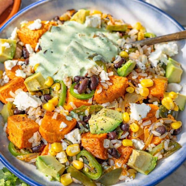 Black Bean and Rice Bowl with Greek Yogurt Cilantro Lime Dressing topped with avocado and feta.