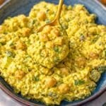 Bowl of curried chickpea salad with spoon.