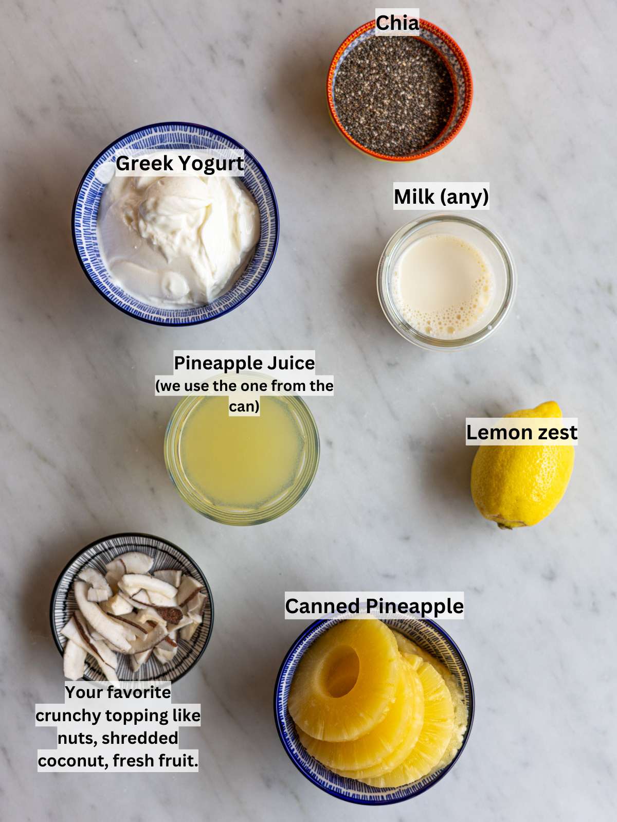 Chia seeds, Greek yogurt, canned pineapple, milk, and lemon on wooden table.