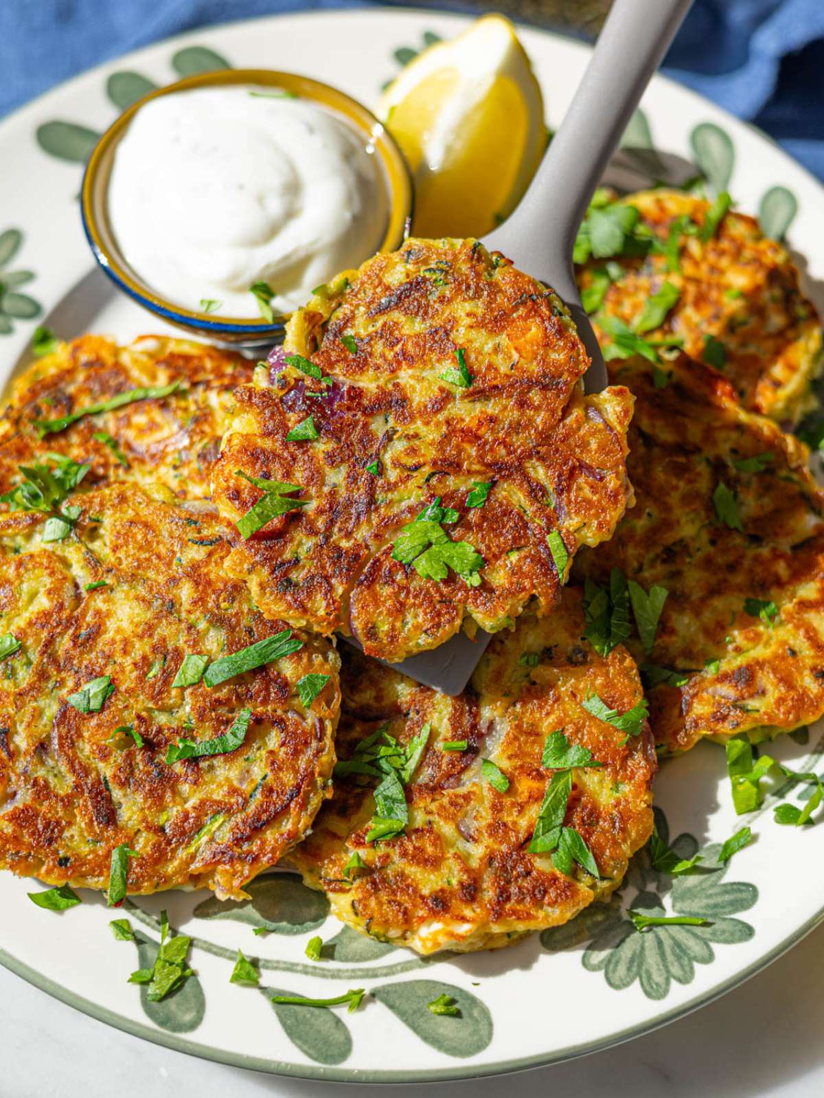 Close up of golden chickpea zucchini fritters showing browned top.