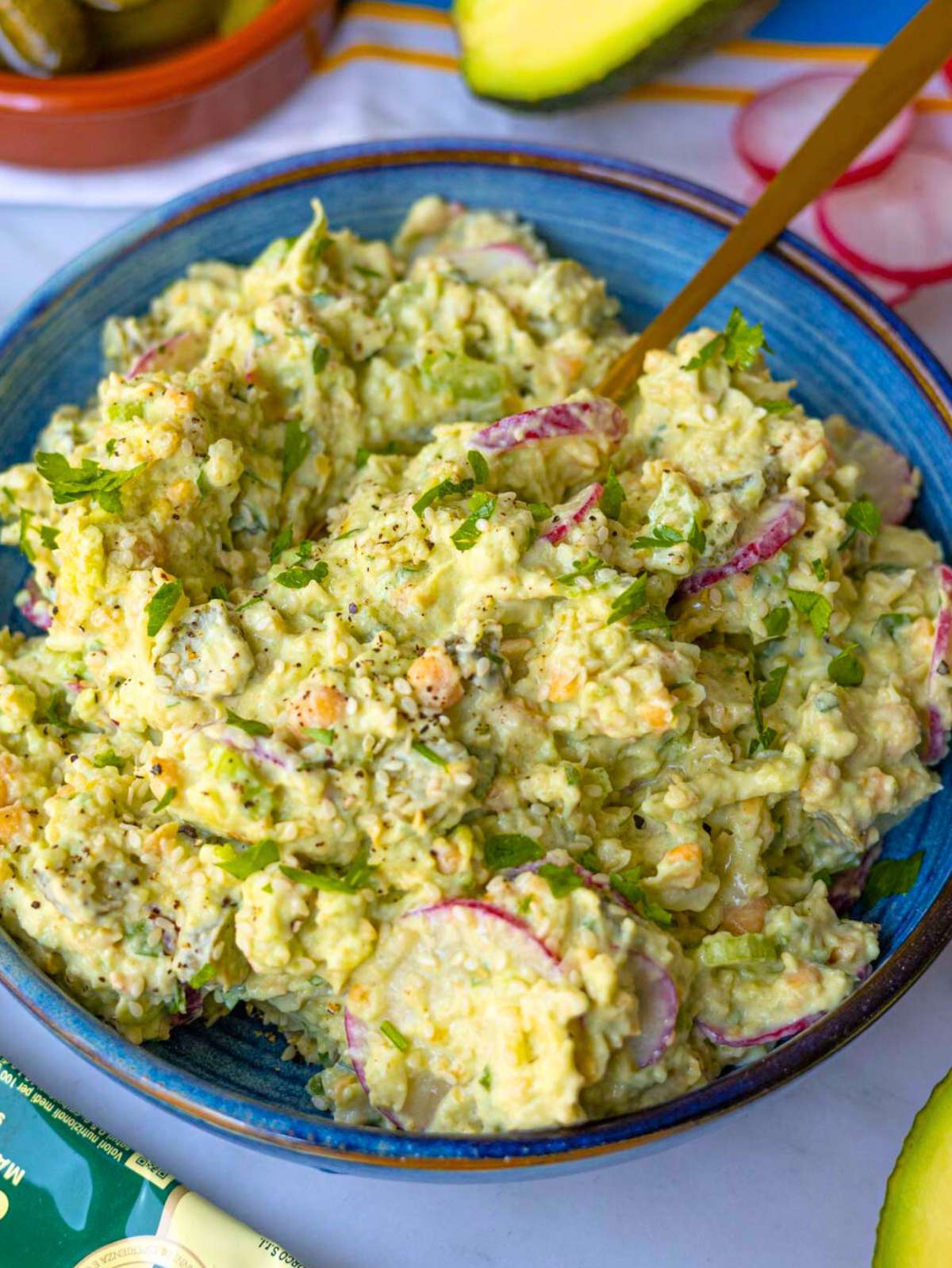 Close-up of mashed chickpea avocado salad showing chunky texture and creamy texture.