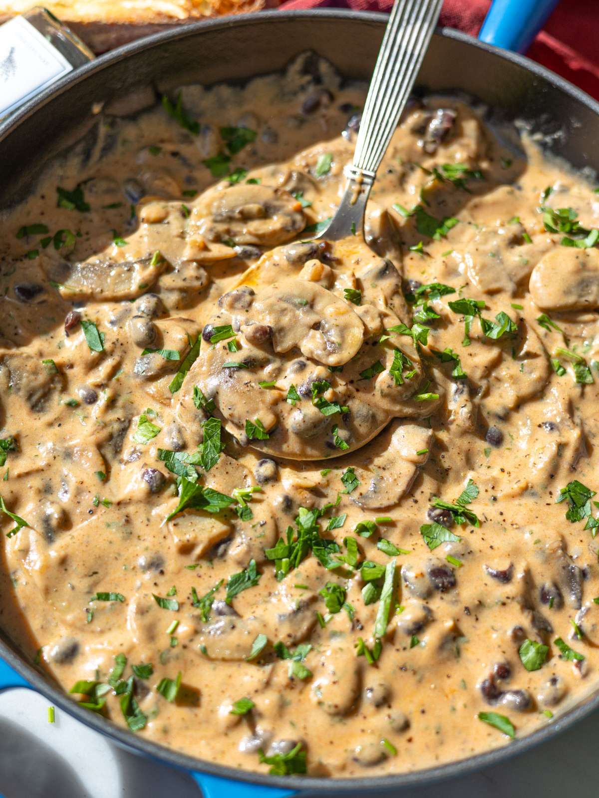 Close up of thick mushroom stroganoff sauce coating mushrooms and beans.