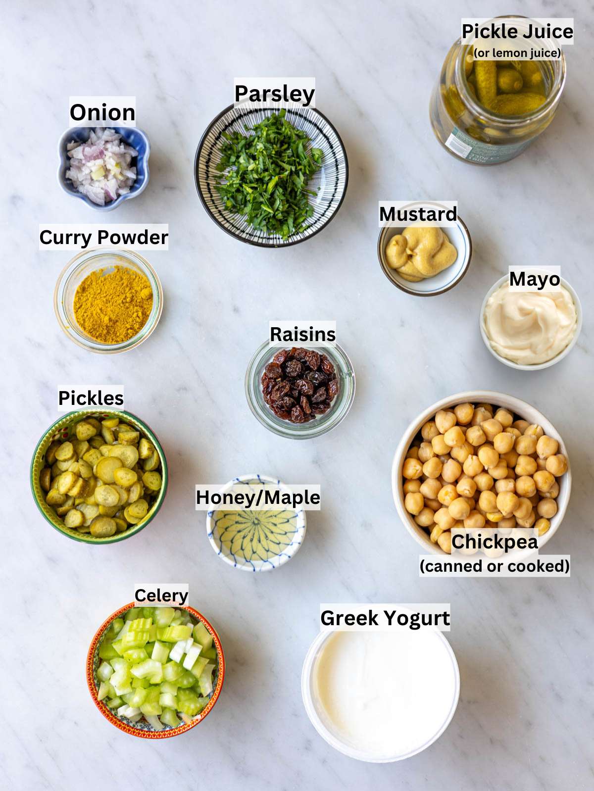 Close up spoonful of lentil noodle soup with pasta and Canned chickpeas, Greek yogurt, celery, pickles, mustard, honey, curry powder on table.