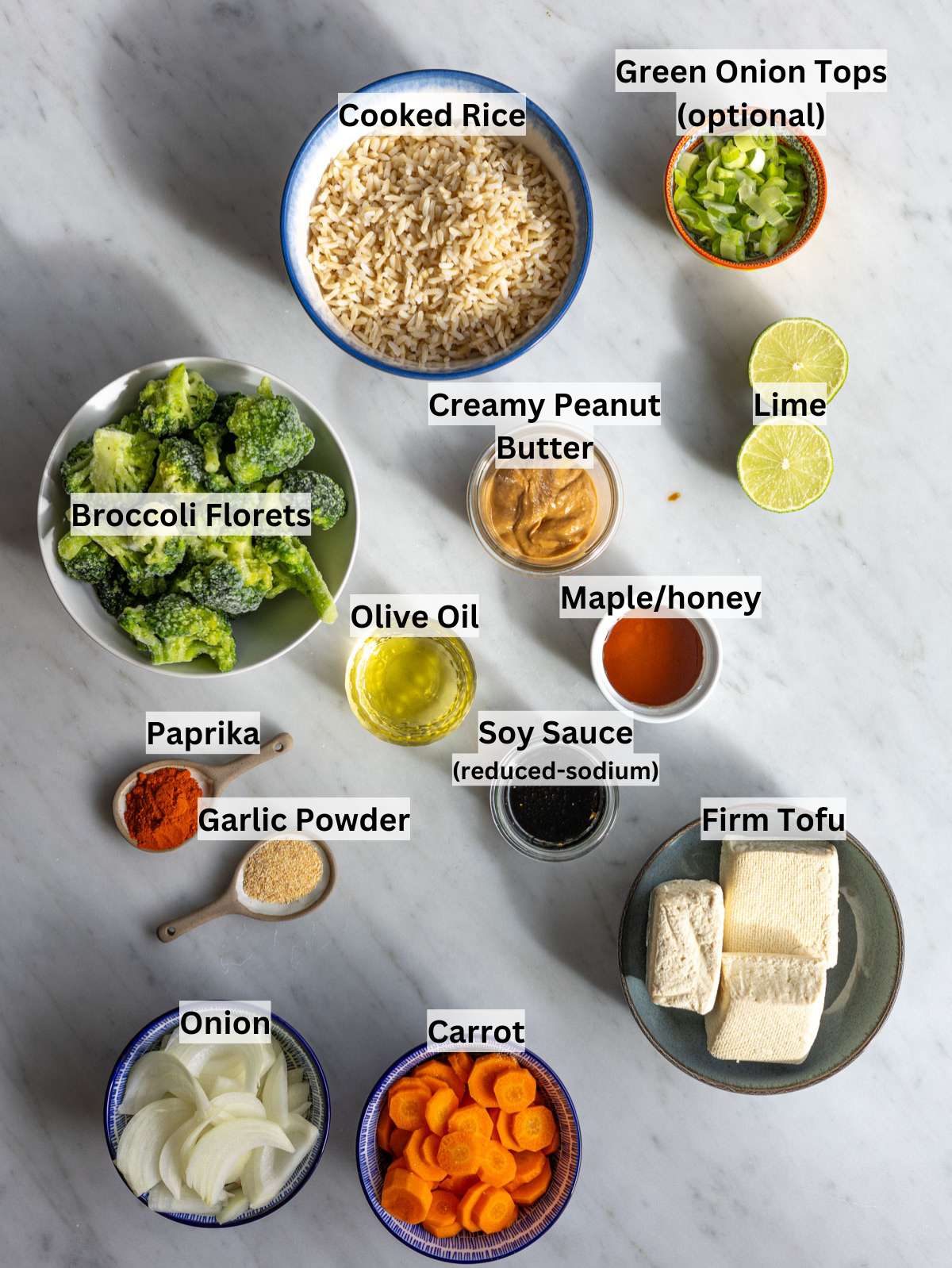 Ingredients for tofu rice bowl including tofu, carrots, onion, broccoli, rice, and peanut sauce basics.