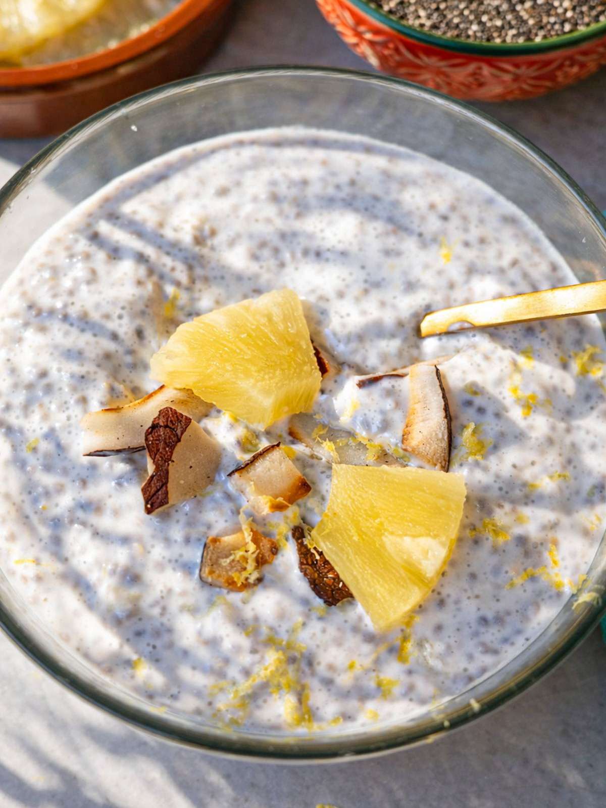 Pineapple chia pudding in breakfast bowl topped with pineapple pieces.