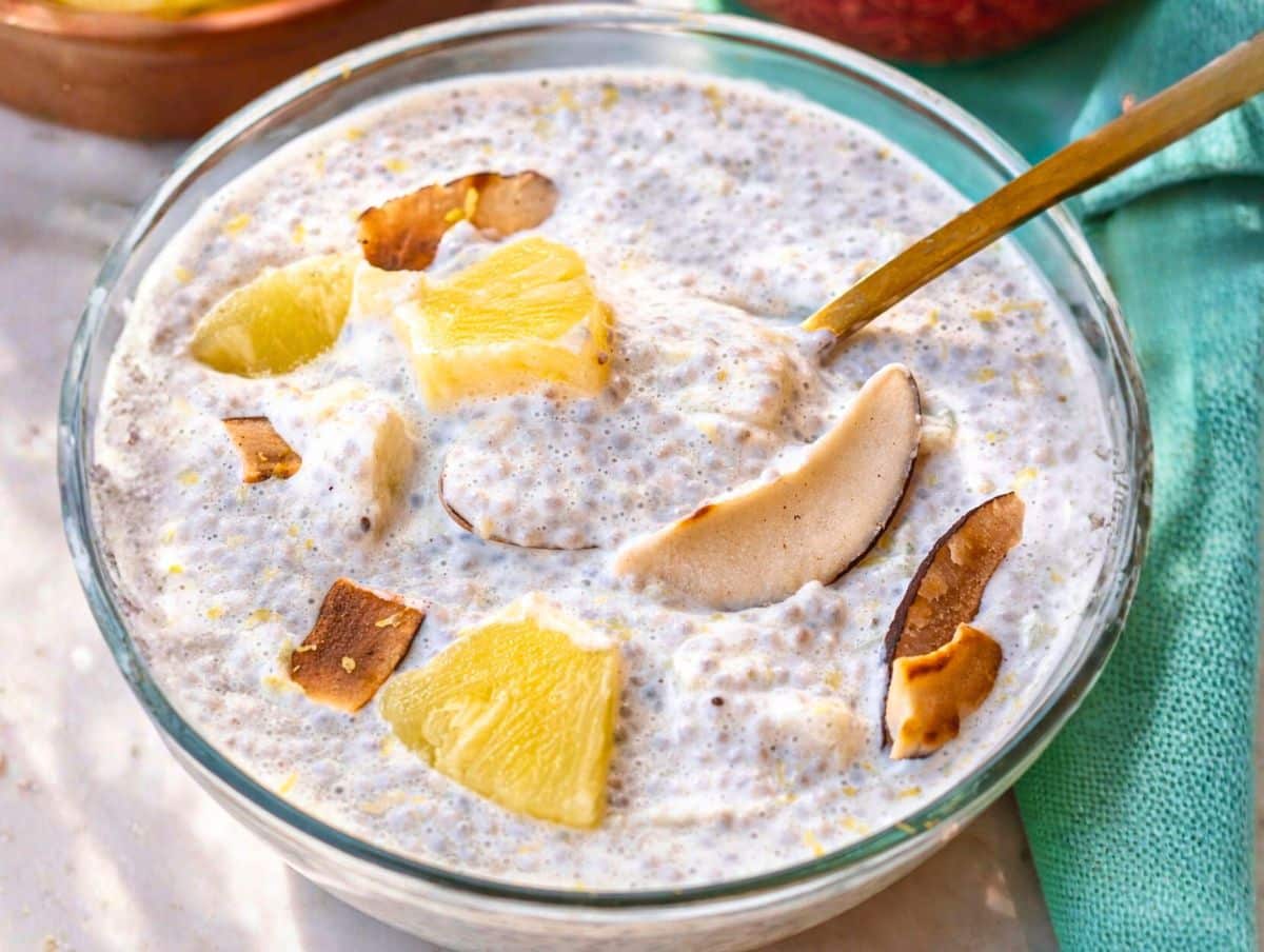 Pineapple chia pudding with yogurt and fruit in bright natural light.