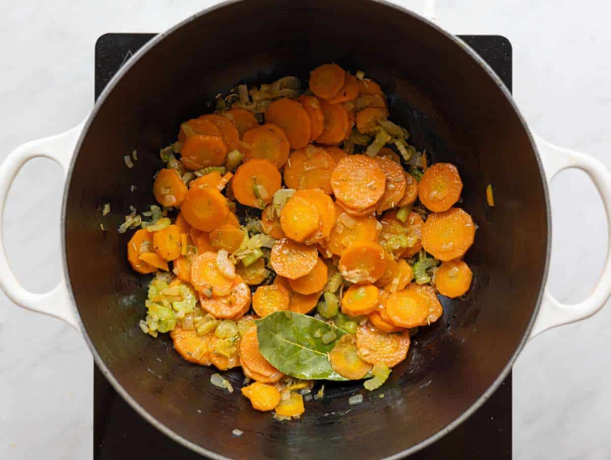 Step 1 Chopped onion, carrots, and celery sautéing gently in olive oil in a large pot.