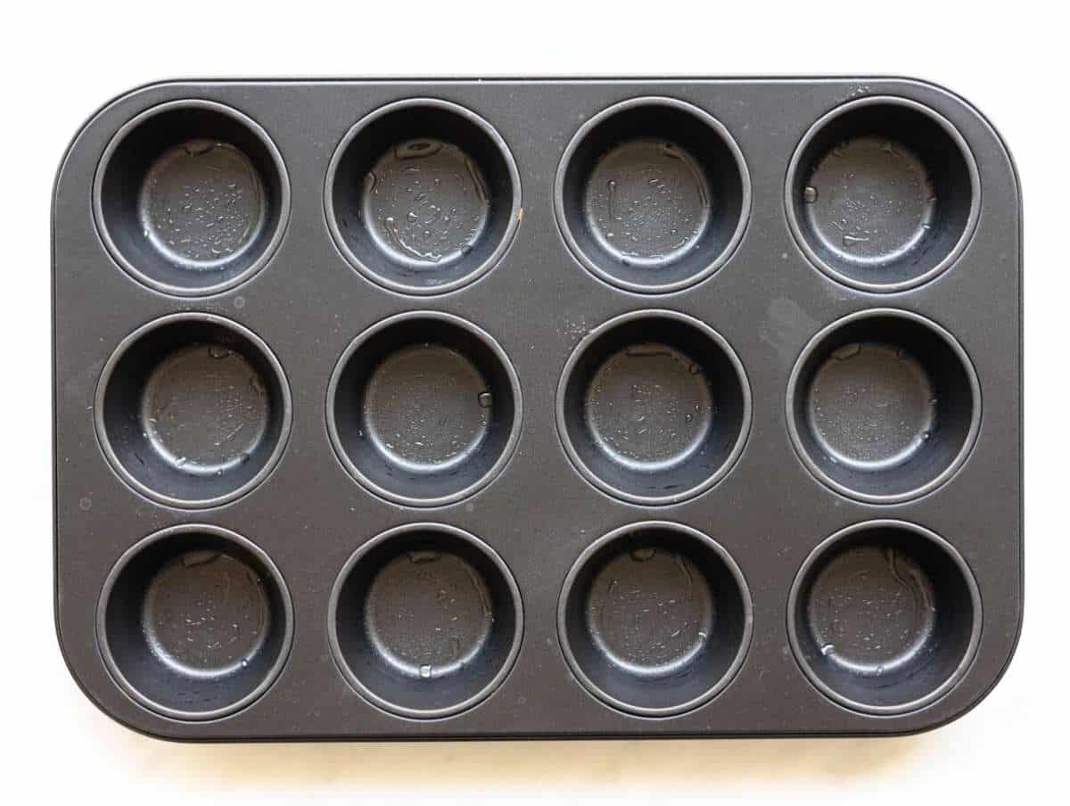 Step 1 Greased 12 cup muffin pan on table