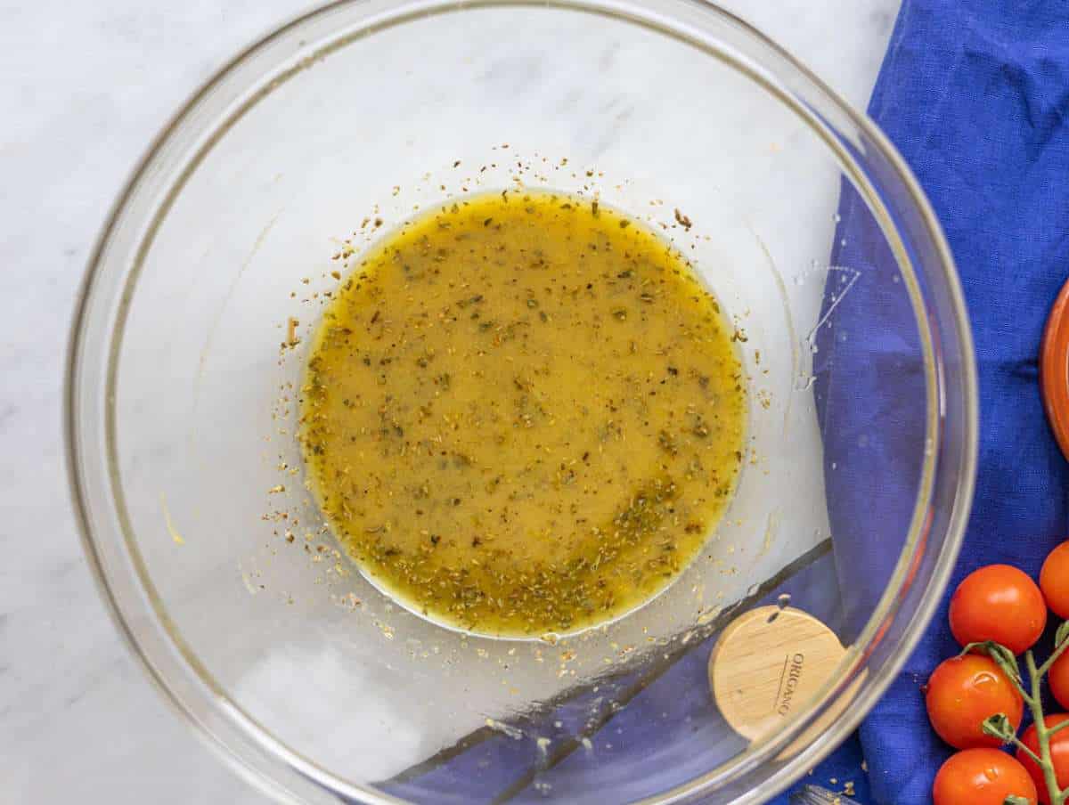 Step 1 Lemon dressing whisked in a large bowl with olive oil mustard and oregano.