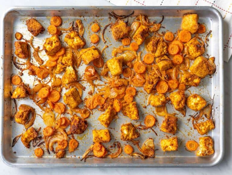 Step 1 Roasted tofu, onion, and carrots on a sheet pan.