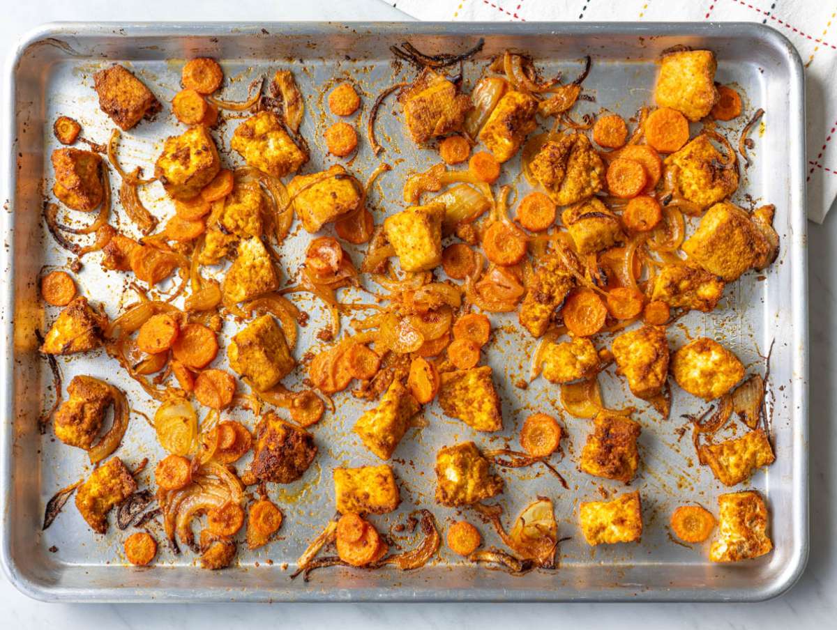 Step 1 Roasted tofu, onion, and carrots on a sheet pan.