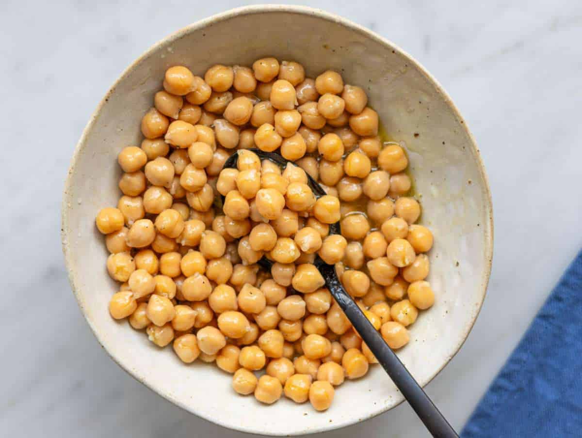 Step 2 Chickpeas tossed in lemon and olive oil dressing in small bowl.