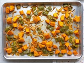 Step 2 Roasted diced sweet potatoes, peppers, and onions spread on baking sheet.