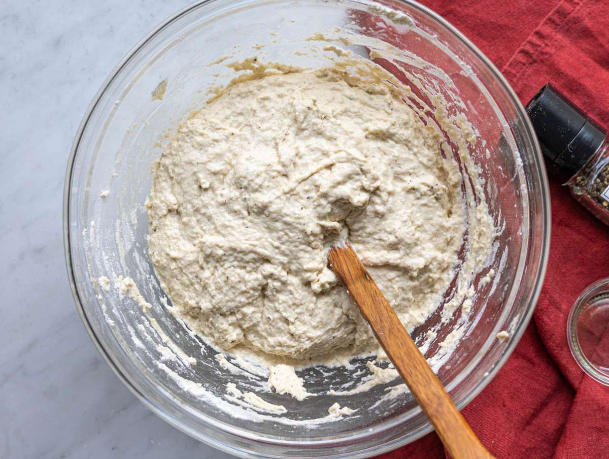 Step 2 Sticky focaccia dough mixed in a bowl with a spoon, no kneading.