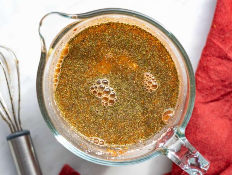 Step 3 Broth and flour mixture being whisked in glass measuring jug.
