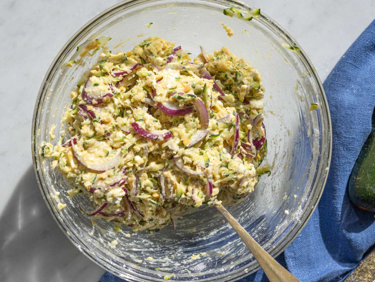 Step 3 Mashed chickpeas mixed with zucchini, feta, and herbs in bowl.