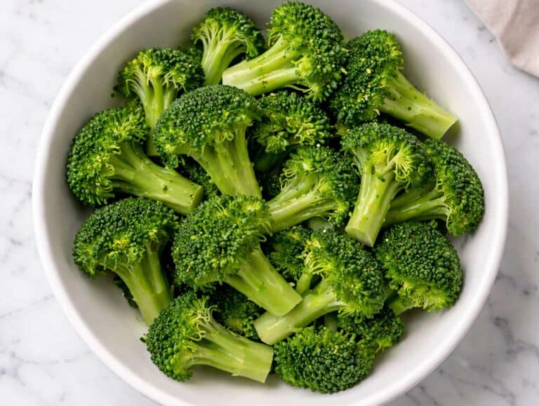 Step 3 Microwaved broccoli florets in a white bowl.
