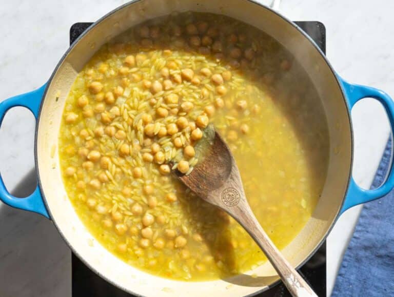 Step 3 Orzo and chickpeas simmering together in vegetable broth.