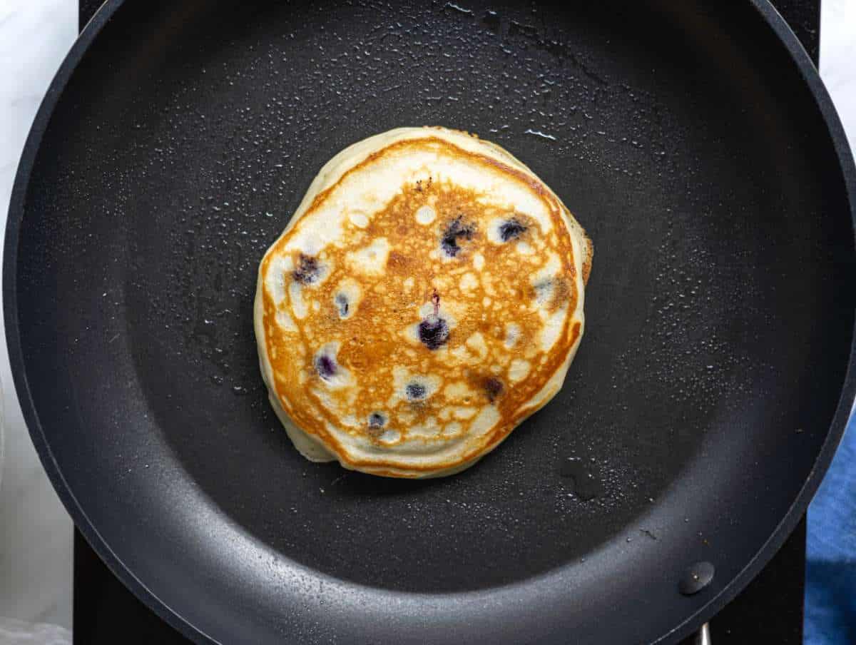 Step 3 Pancake flipped in skillet showing golden brown surface.