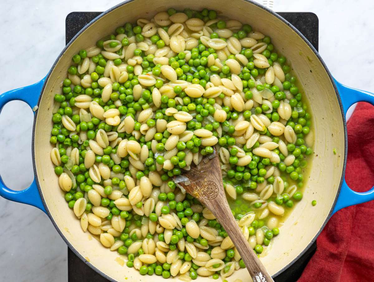 Step 3 Pasta cooking in vegetable broth with peas creating a creamy sauce.