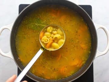 Step 3 Pasta simmering in the soup as noodles soften and swell in the broth.