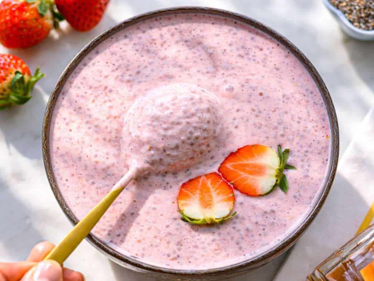 Step 3 Stirring chilled chia pudding before serving with fresh strawberry topping.