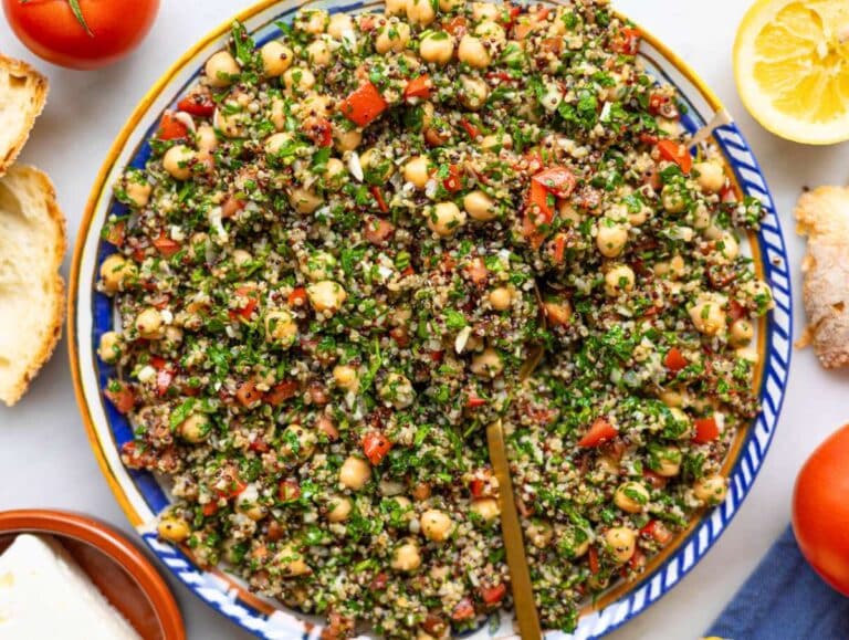 Step 4 Chickpea quinoa bowl served on a platter next to feta and bread.
