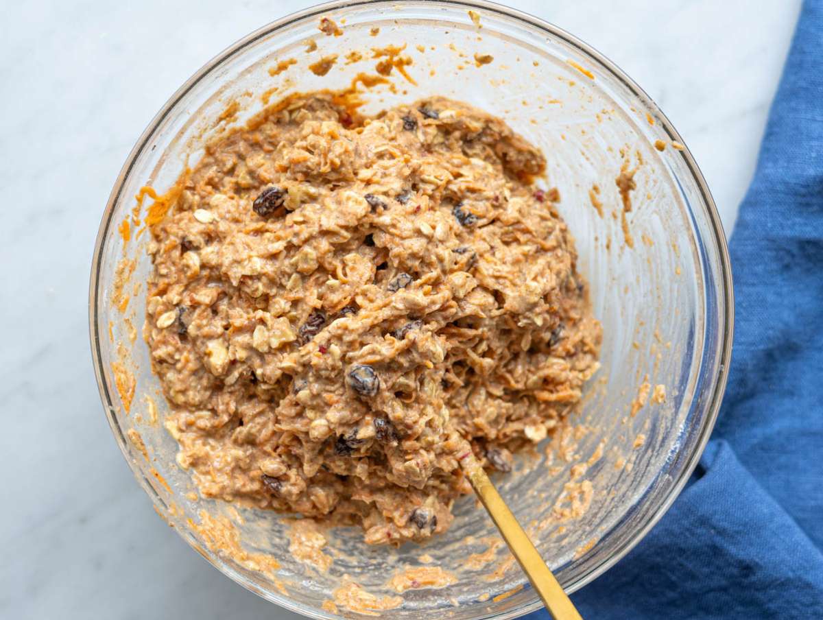 Step 4 Folding grated carrots, apple, raisins, and pecans into thick batter.