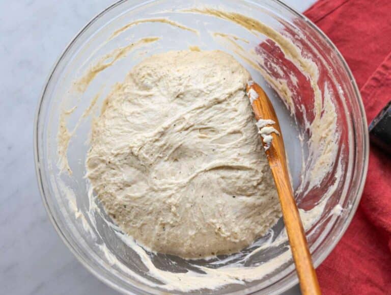 Step 4 Folding soft focaccia dough over itself with a spoon.