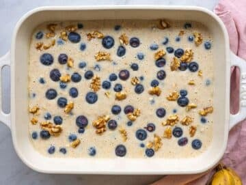 Step 4 Oat mixture spread in baking dish topped with blueberries and walnuts.