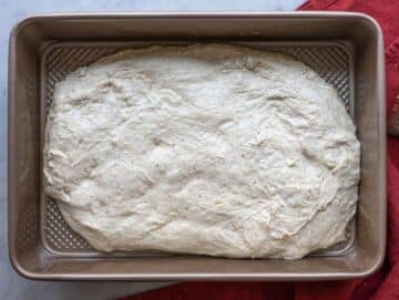 Step 5 Dough spread into an oiled baking pan before second rise