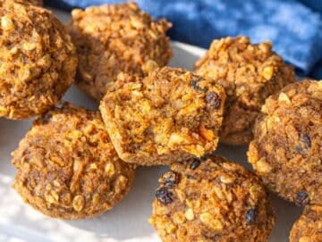 Step 5 Morning glory muffins cooling on marble table with one cut open showing soft center.