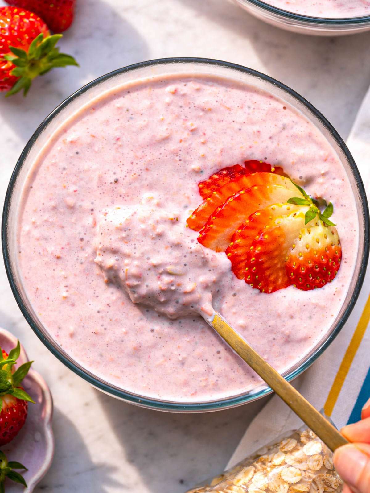 Top down of thick, creamy strawberry overnight oats with visible oat texture.