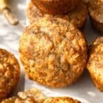Tray of freshly baked healthy banana nut muffins cooling naturally in a bright kitchen.