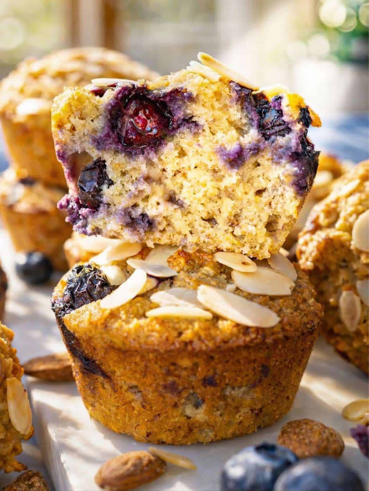 A detailed view of a moist muffin showing bursting blueberries and a golden crumb.