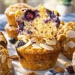 Almond flour blueberry muffins with Greek yogurt stacked neatly under bright, natural light.