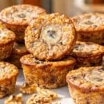 Banana baked oatmeal cups stacked on a marble table.