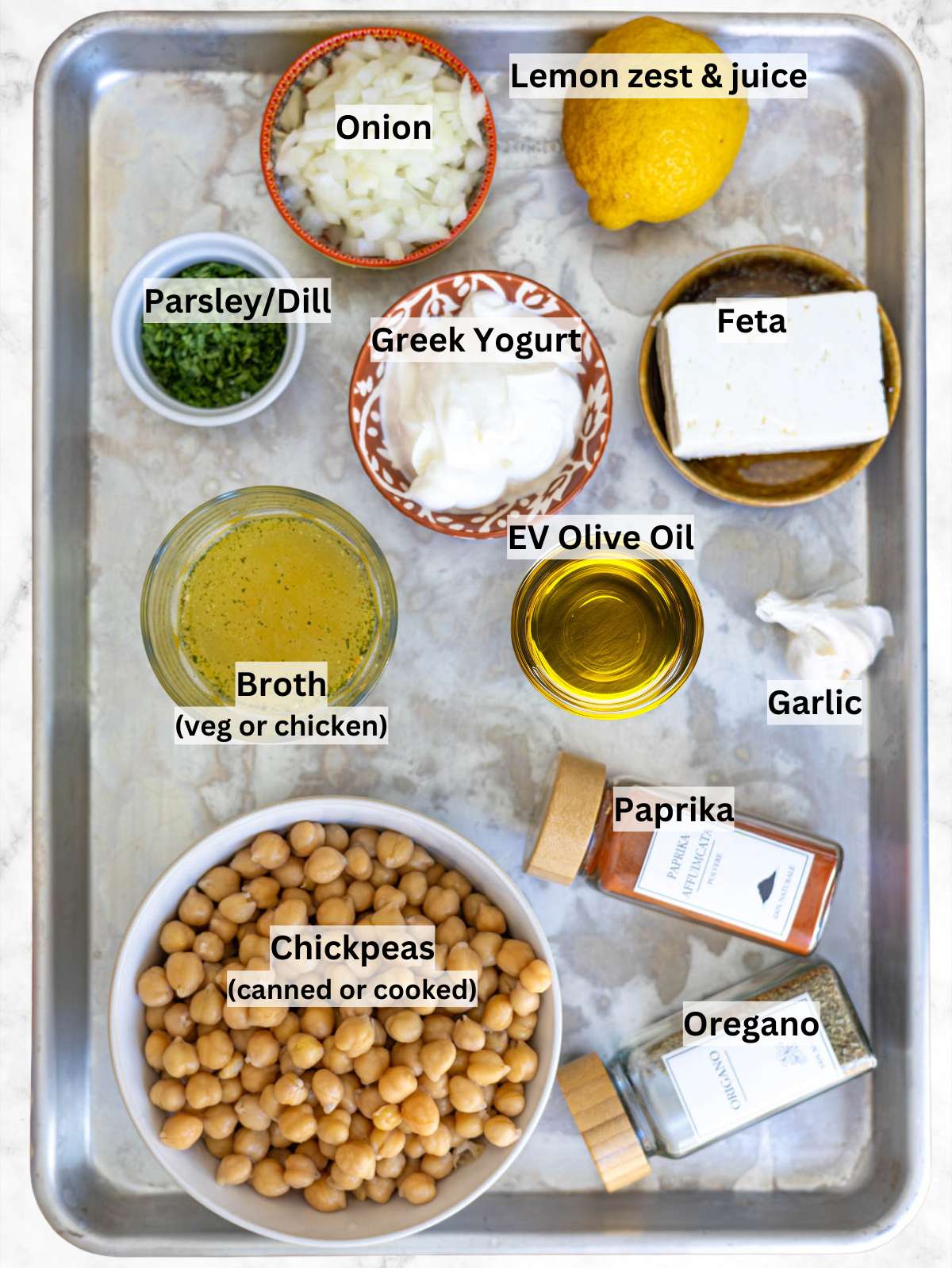 Close up of Greek potato salad showing tender potatoes feta olives and fresh herbs.