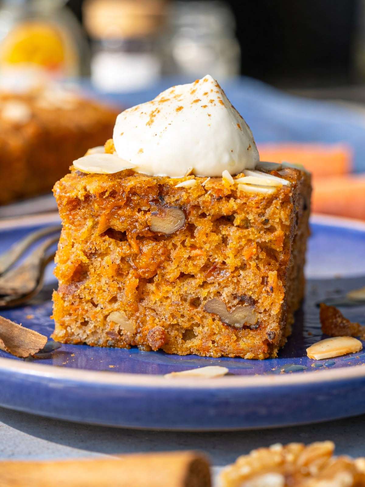 Close up of moist carrot cake crumb with walnuts and raisins.