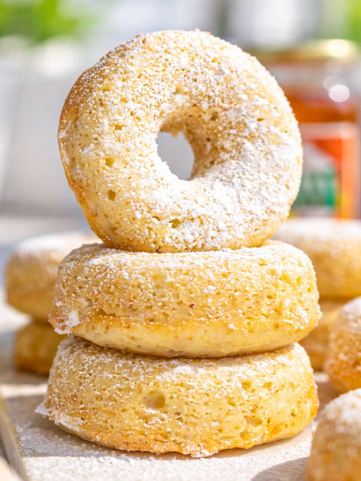 Close up of soft Greek yogurt cake donut showing tender crumb and golden edges.