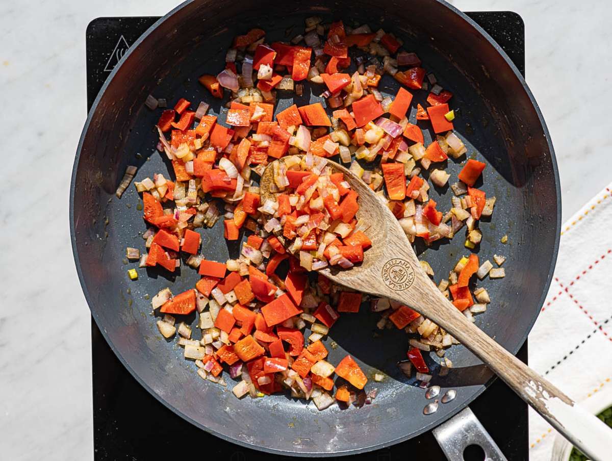 Step 1 Sliced red onion and bell pepper cooking in skillet with olive oil.