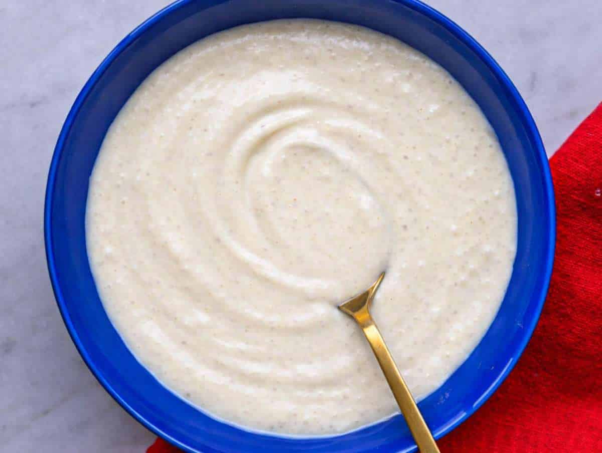 Step 1 Whisking creamy Caesar dressing with yogurt mayonnaise Parmesan garlic and capers in bowl.