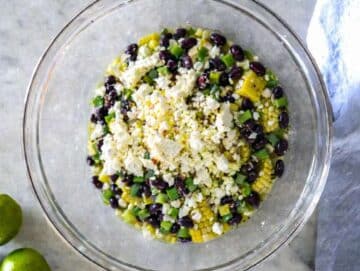 Step 2 Black beans bell pepper corn red onion jalapeños and feta in mixing bowl.
