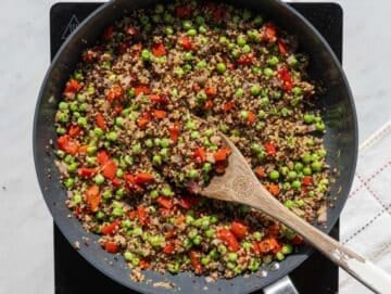 Step 2 Cooked quinoa and peas added to skillet with vegetables and garlic.