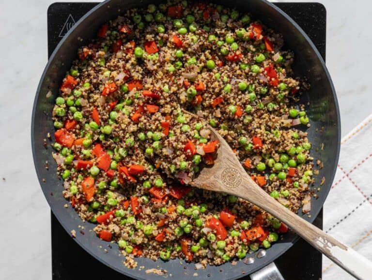 Step 2 Cooked quinoa and peas added to skillet with vegetables and garlic.