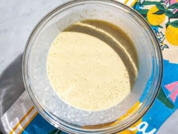 Step 2 Mashed banana mixed with yogurt, egg, and milk in a glass bowl.