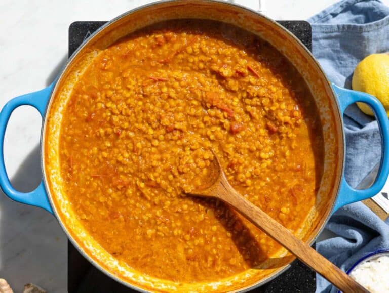 Step 2 Red lentils and crushed tomatoes simmering in a savory vegetable broth.