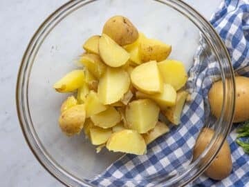 Step 2 Warm potatoes cut into chunks and tossed with vinegar in a bowl.