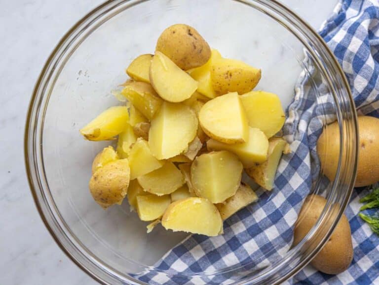 Step 2 Warm potatoes cut into chunks and tossed with vinegar in a bowl.